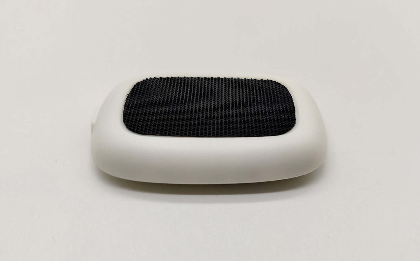 Smart posture corrector device with a sleek design and textured surface for improved back support.