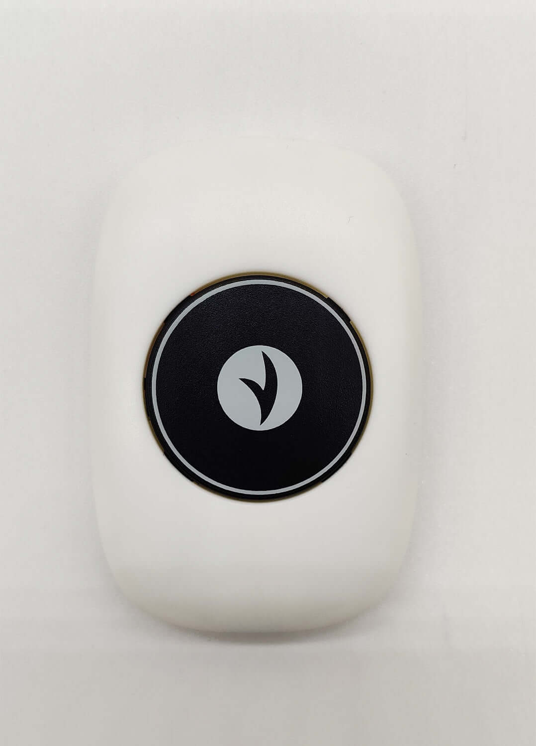 Smart posture corrector device with a minimalist design and an intuitive control button.