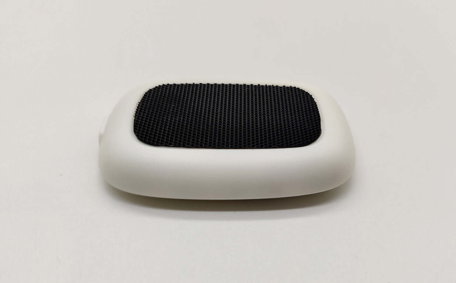 Smart posture corrector device with a sleek design and textured surface for improved back support.